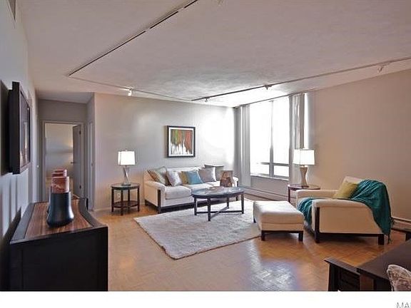 Behind the TV wall (on the left) is a galley kitchen with a buffet bar for serving which can double as a breakfast table