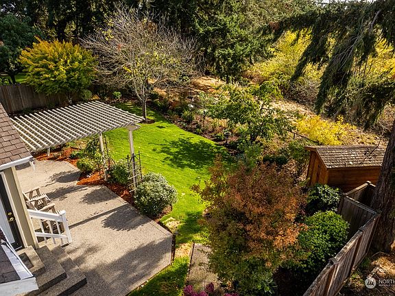 Extened Patio to sit and enjoy the  lovingly cared for backyard including the birds and the bees, flowers and the trees! >
