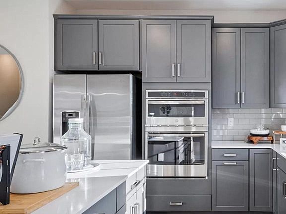 specialized cabinets with 2 ovens and stainless steel appliances
