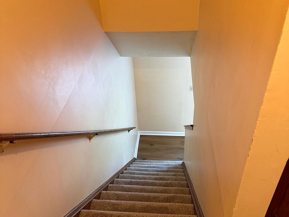 Stairway from top floor/bedroom and full bath area down to main floor/living room/kitchen area.