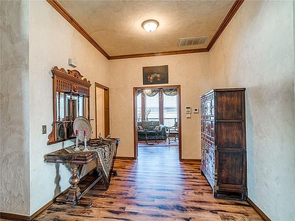 The elegant entry area has planked flooring.  Notice the muraled ceiling.