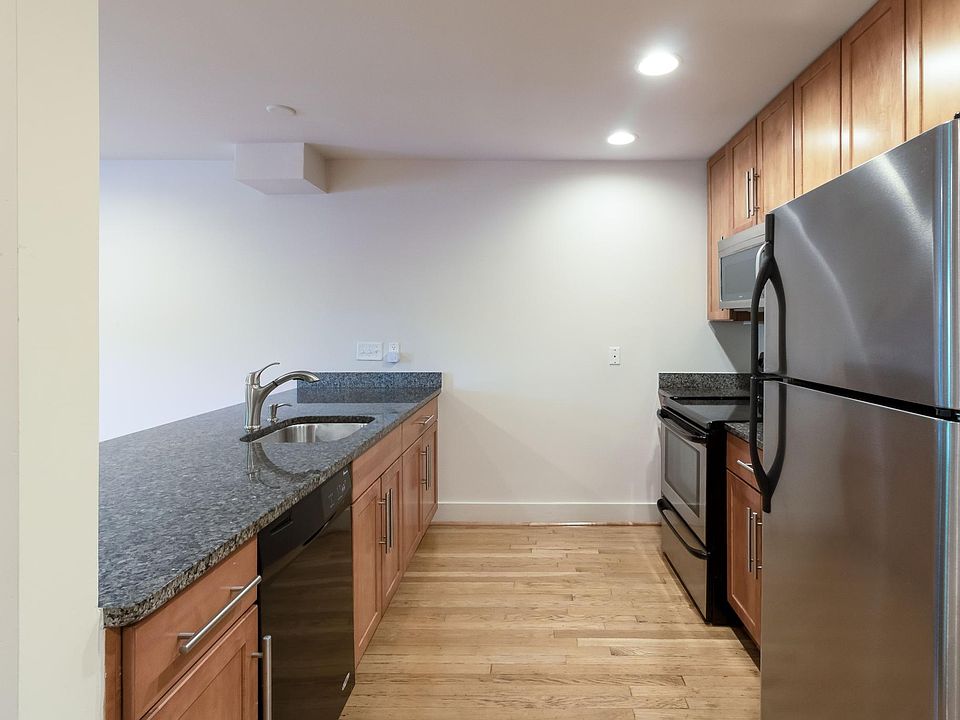 Kitchen with DW, Refrigerator with ice maker and microwave.