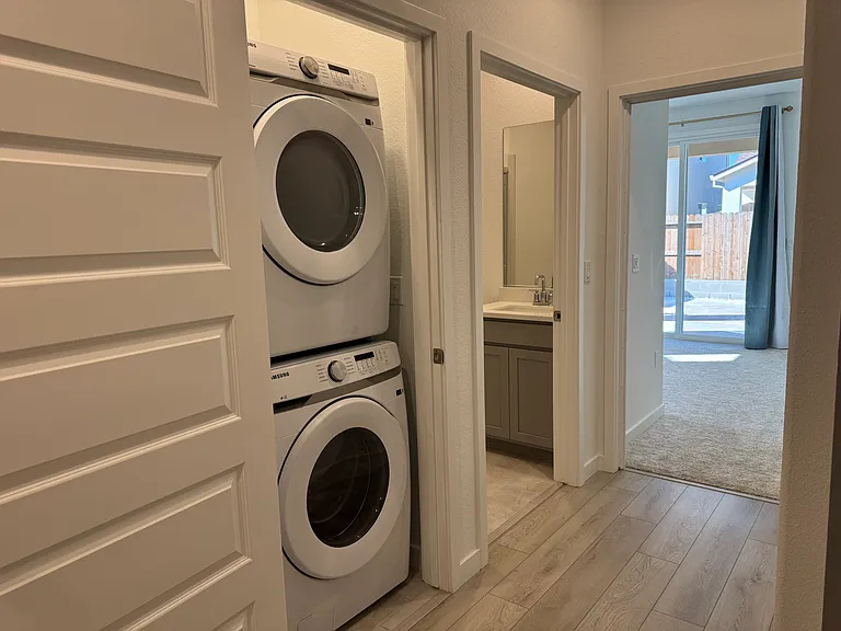 View of laundry room, bathroom, and bedroom.