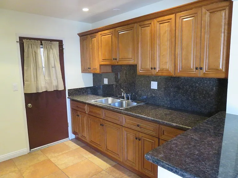 View of kitchen, across from stove/range.