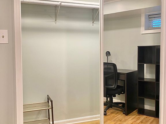 Mirrored sliding door closet w/ rail and shelving