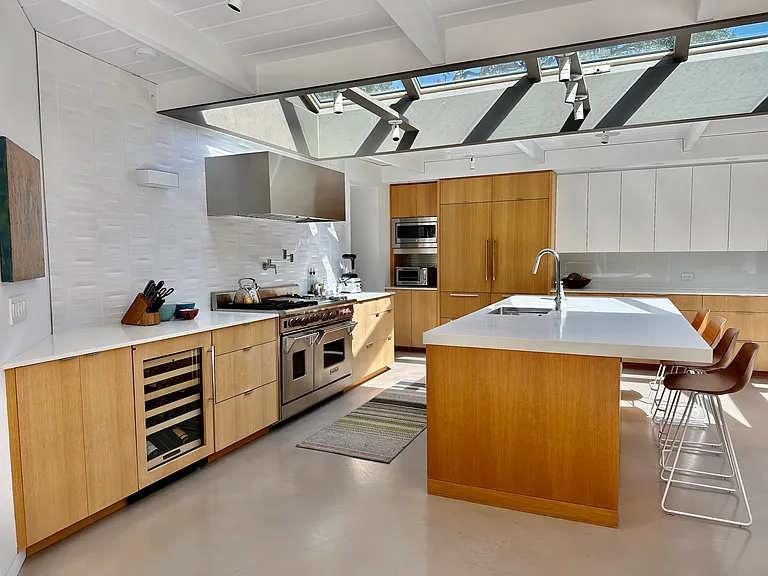 Wine fridge, ample cabinet space and a pantry with a desk nook for children