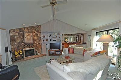 Great Room with stone fireplace, cathedral ceilings and wet bar