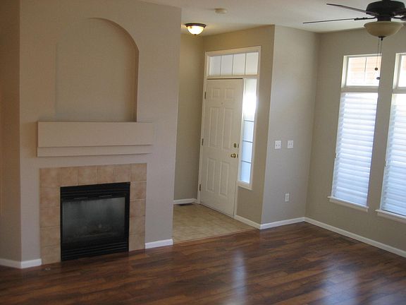 Living room with gas fireplace and dining area.
