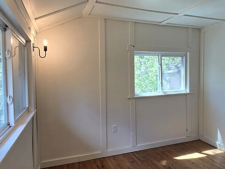 Primary bedroom with south- and west-facing windows.