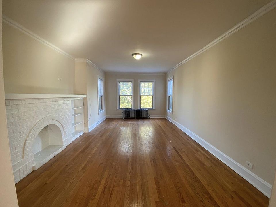 Large, Sunny Third Floor Living Room with Decorative Fireplace