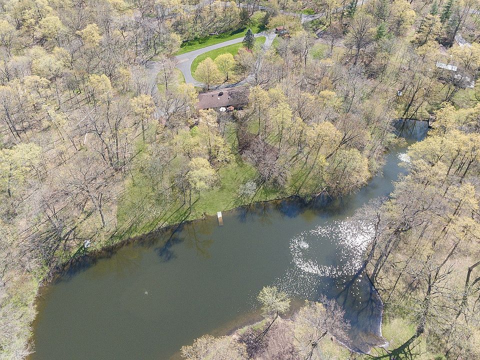The 3+ acre lot has mature trees and is 1 of 4 homes located on the pond.