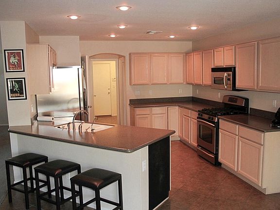 Open Kitchen with Stainless GE Appliances and built-in pantry.