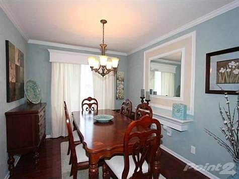 The Formal Dining room flows from the Living room into the Kitchen;  The custom crown molding and window cornices all also featured throughout the home.