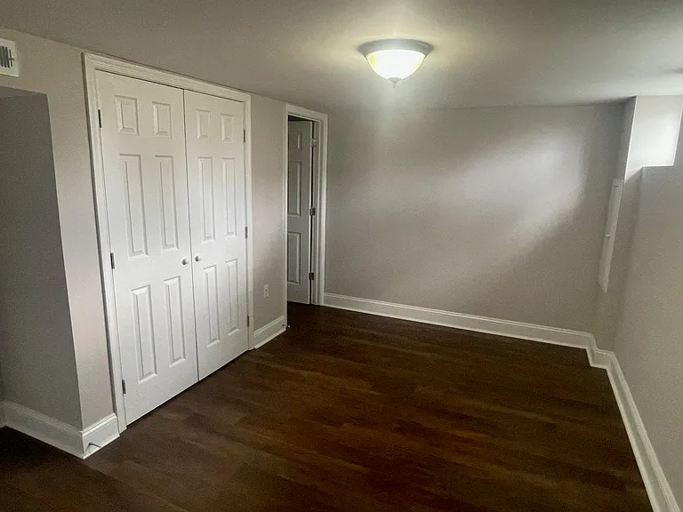 basement bedroom with bathroom on left
