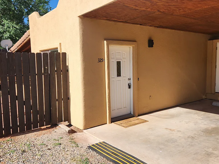 Single Carport Adjacent to Entry Door & Gate to Backyard