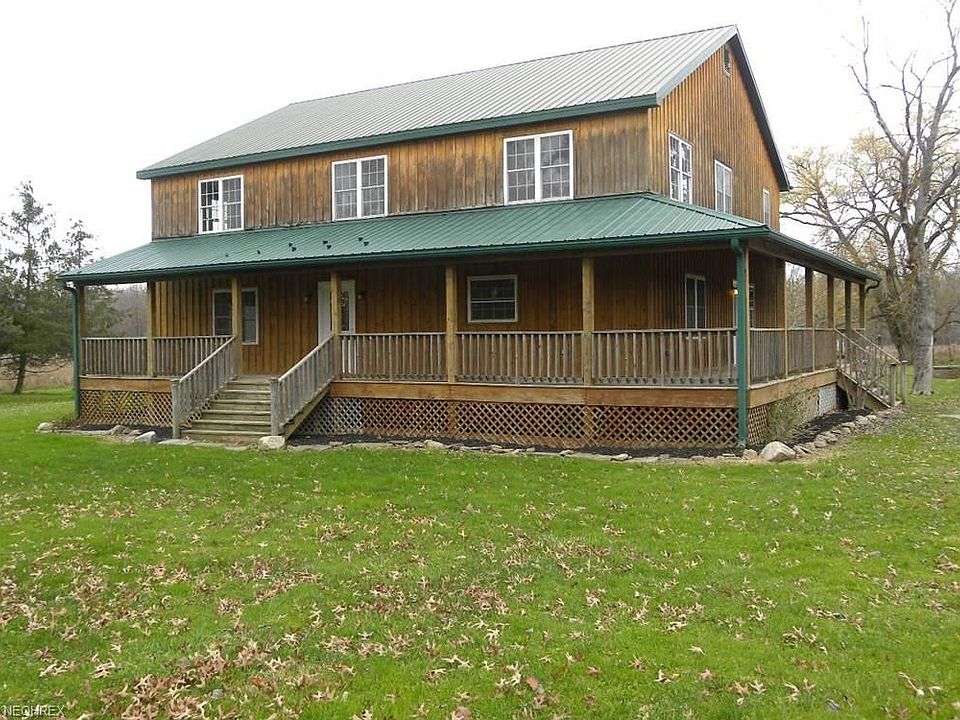 Spacious 4 bedroom farmhouse on 26+ acres with metal roof and walk-out basement.