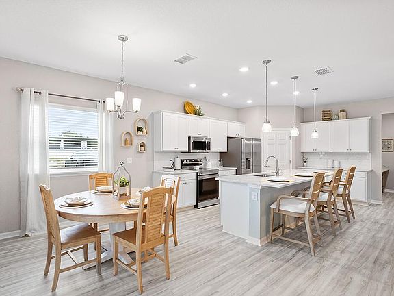 Meals are a delight in your new open kitchen with a counter-height island, walk-in pantry, and sunny