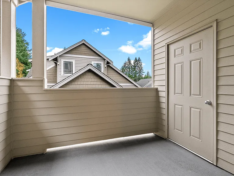 Covered private balcony with outdoor storage and peaceful neighborhood views. Covered private balcony with outdoor storage and peaceful neighborhood views.