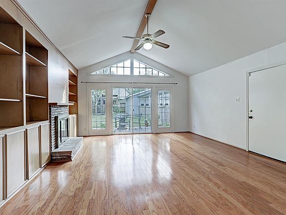 Family Room/Den. Door to the right leads to covered walkway, driveway and side yard.