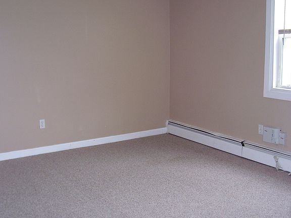 Bedroom with large closet and large windows.