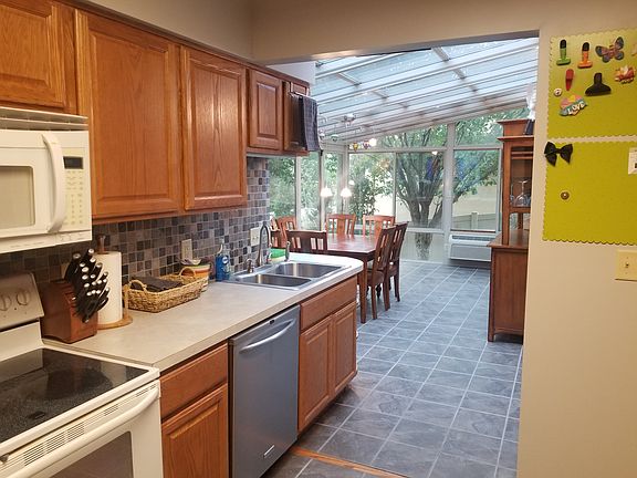 Kitchen leading into attached sunroom