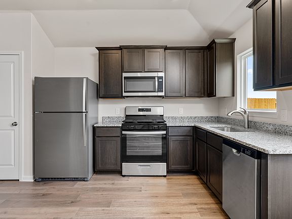The kitchen has sprawling granite countertops.