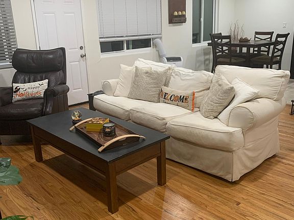 Living room, which backs up to the dining room. The door pictured here is the back door leading to the back yard and the private entrance to the laundry/storage.