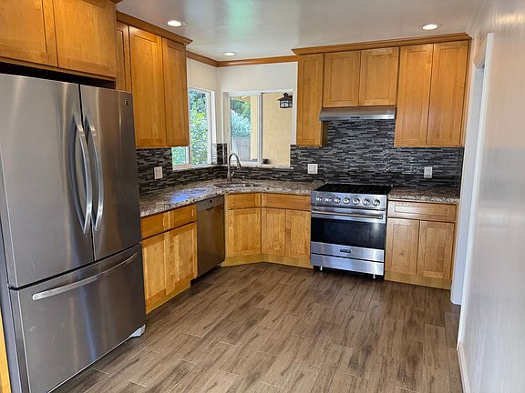 Kitchen. Looks into front yard. Tile floor.