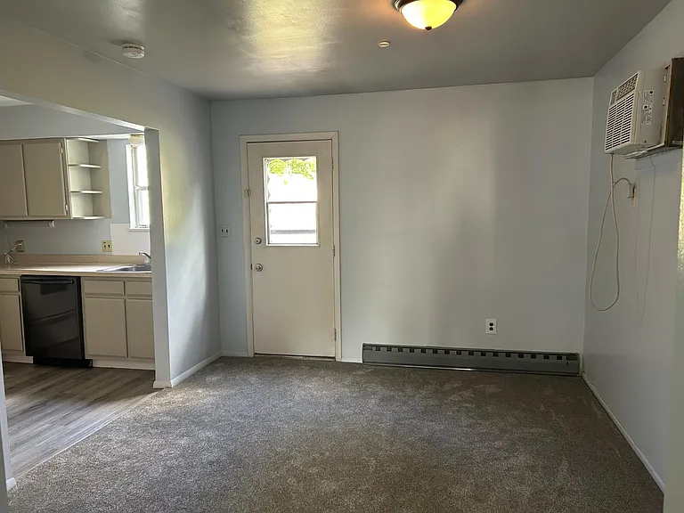 Large dining room with huge AC to cool entire floor with entrance onto patio