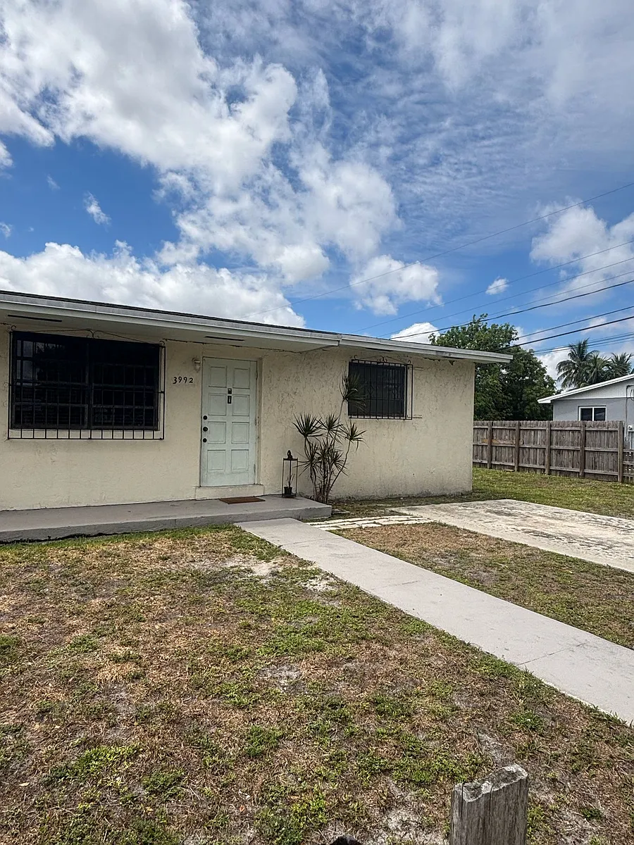Main entrance with car space (fenced) - 3992 NW 159th St