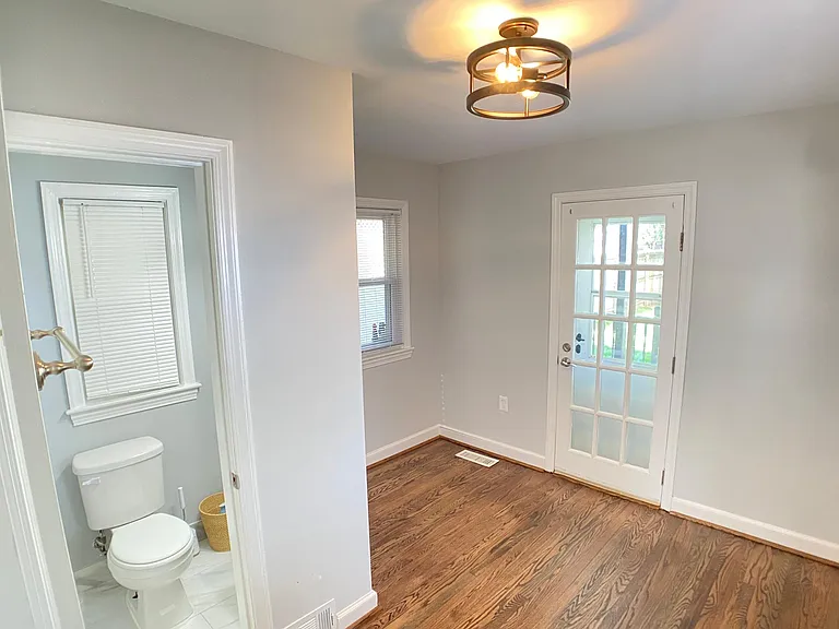 Bedroom 3 (main level) with full bathroom, to include a stand-up shower. Opens to covered rear porch.