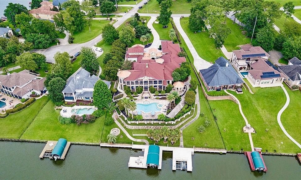 Estate is situated on 1.2 acres and has 170 ft of waterfront on Lake Conroe.