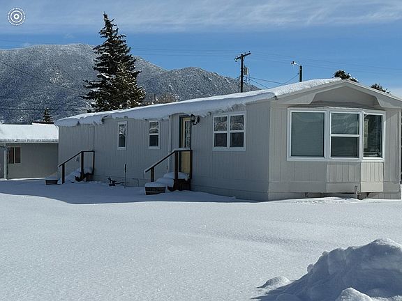 Front elevation in the winter facing southeast with Eastridge & Maud S Canyon in the background.