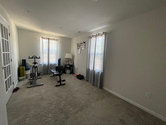 Recreation room / gym room on first floor with powder room, store room & coat closet.