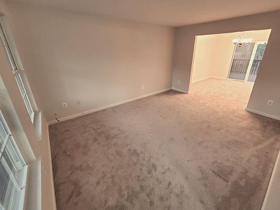 Spacious Living Room From Front Entrance Leads to Dining Room