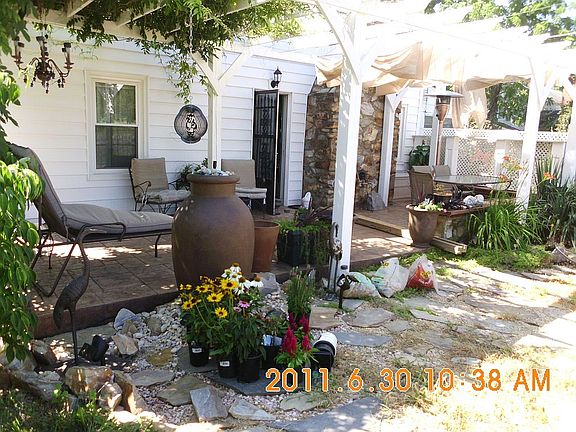 side patio with arbor and water feature