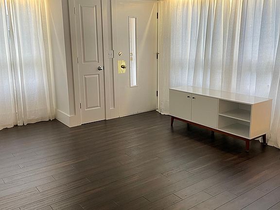 Living room, front door, & coat closet.