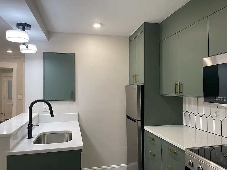 Kitchen inclues a garbage disposer, dishwasher, and plenty of storage cabinets.