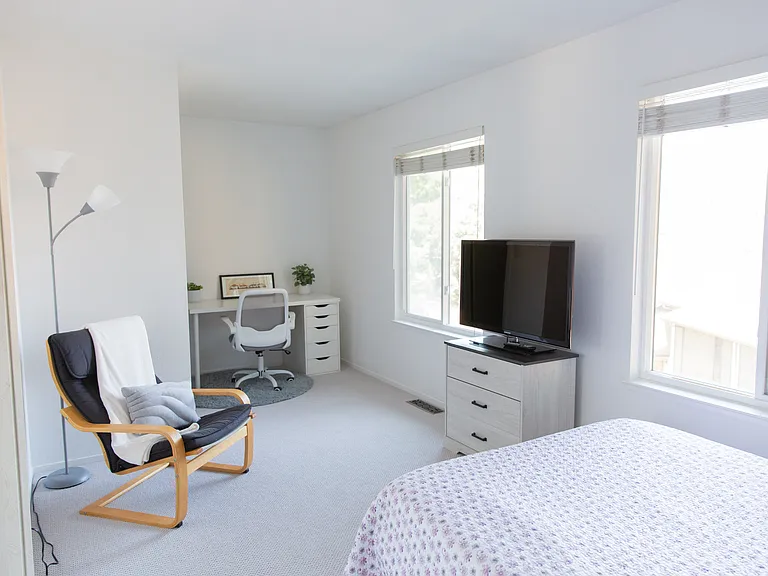 Second bedroom with view of Carquinez Bridge, work station, TV, and walk-in closet.