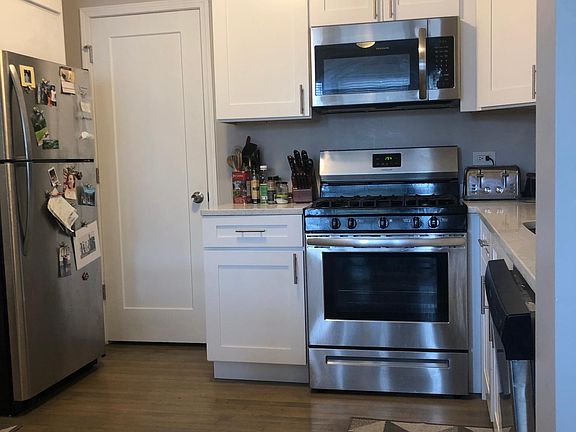The door in this photo leads to an in-unit washer and dryer and storage area