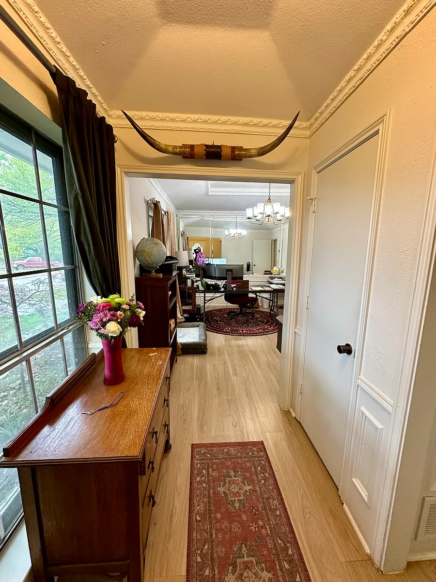 Entry hallway with ornamental molding, light wood finished floors and a chandelier - 7145 Crooked Oak Dr