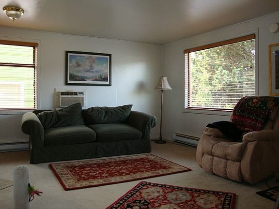 living room with newer carpet and window blinds!