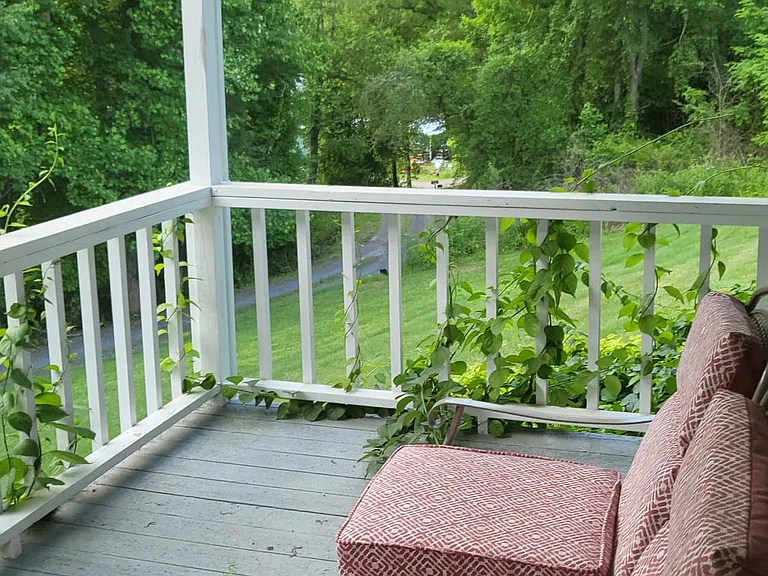 Front porch overlooking your private road along a line trees