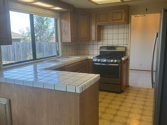 Kitchen has a City and Backyard View