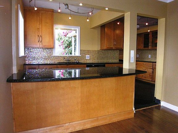 Large granite bar open to kitchen
