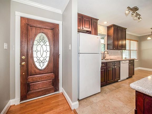 Remodeled kitchen with tile floors & updated lighting.