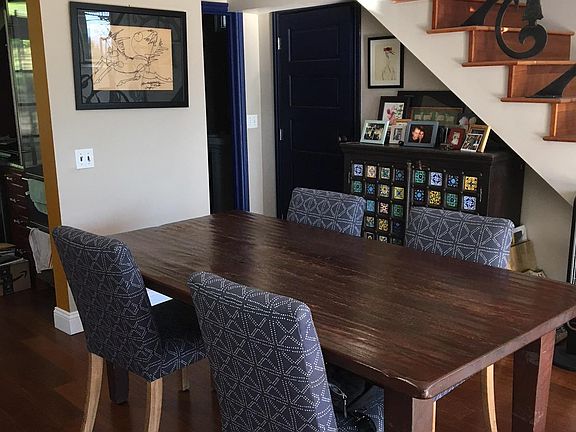 Dining area off of kitchen. Under stair storage. Full bath is the open door.