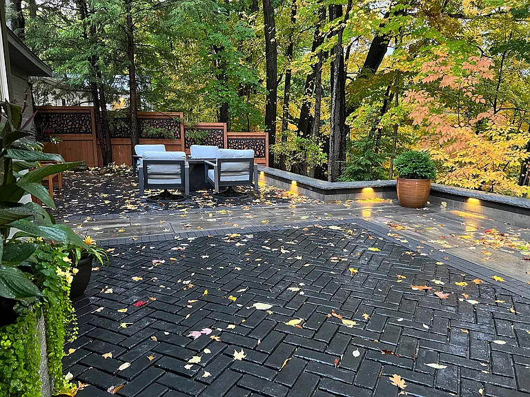 custom brick patio with swivel rockers and fire table