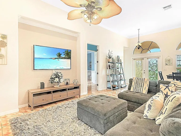 Spacious living room with sectional seating, media wall, and easy flow to the dining area and front entry.