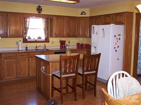 Spacious kitchen with center island and dining area.